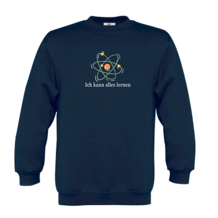navyfarbiges Kinder-Sweatshirt mit der Aufschrift „Ich kann alles lernen“ unter einer stilisierten bunten Atom-Grafik. Das Design vermittelt Neugier, Lernfreude und Wachstum.
