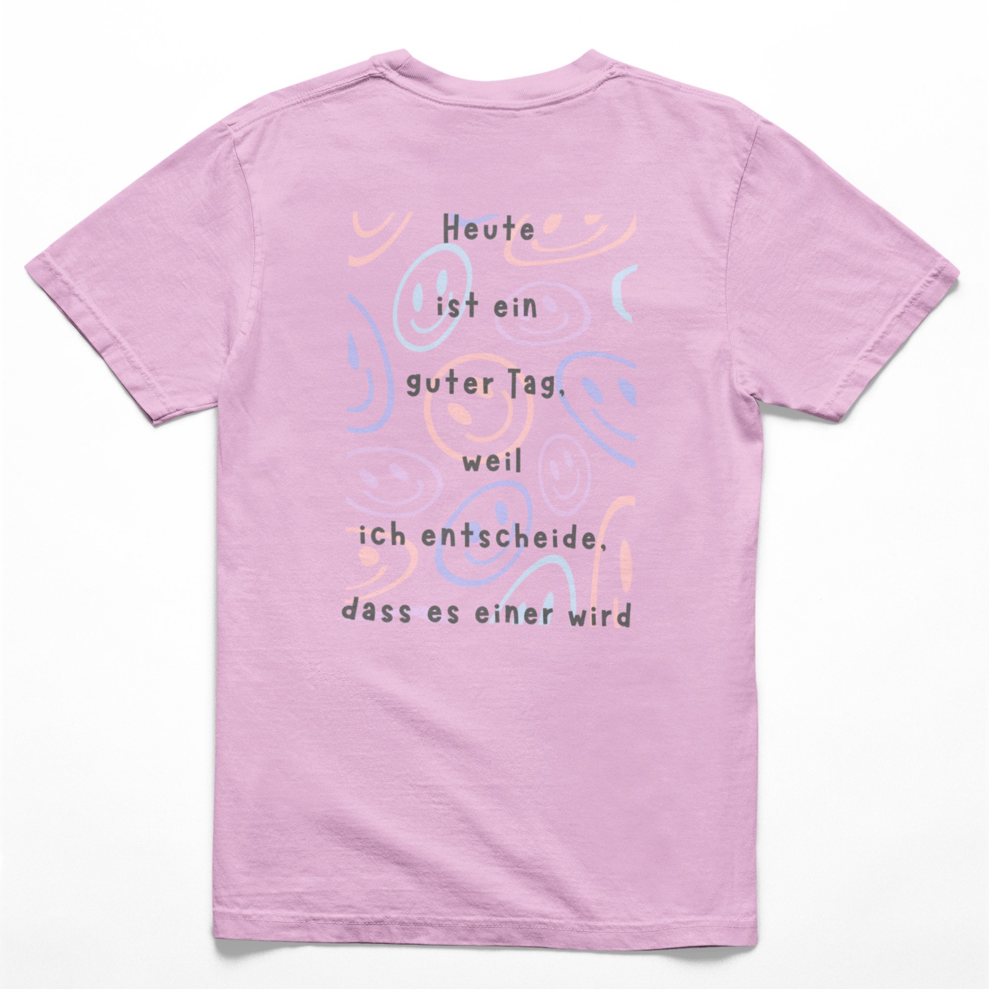 Rückseite eines light-pinkes Kinder-T-Shirts mit farbenfrohem Smiley-Muster und dem Spruch: ‚Heute ist ein guter Tag, weil ich entscheide, dass es einer wird.‘