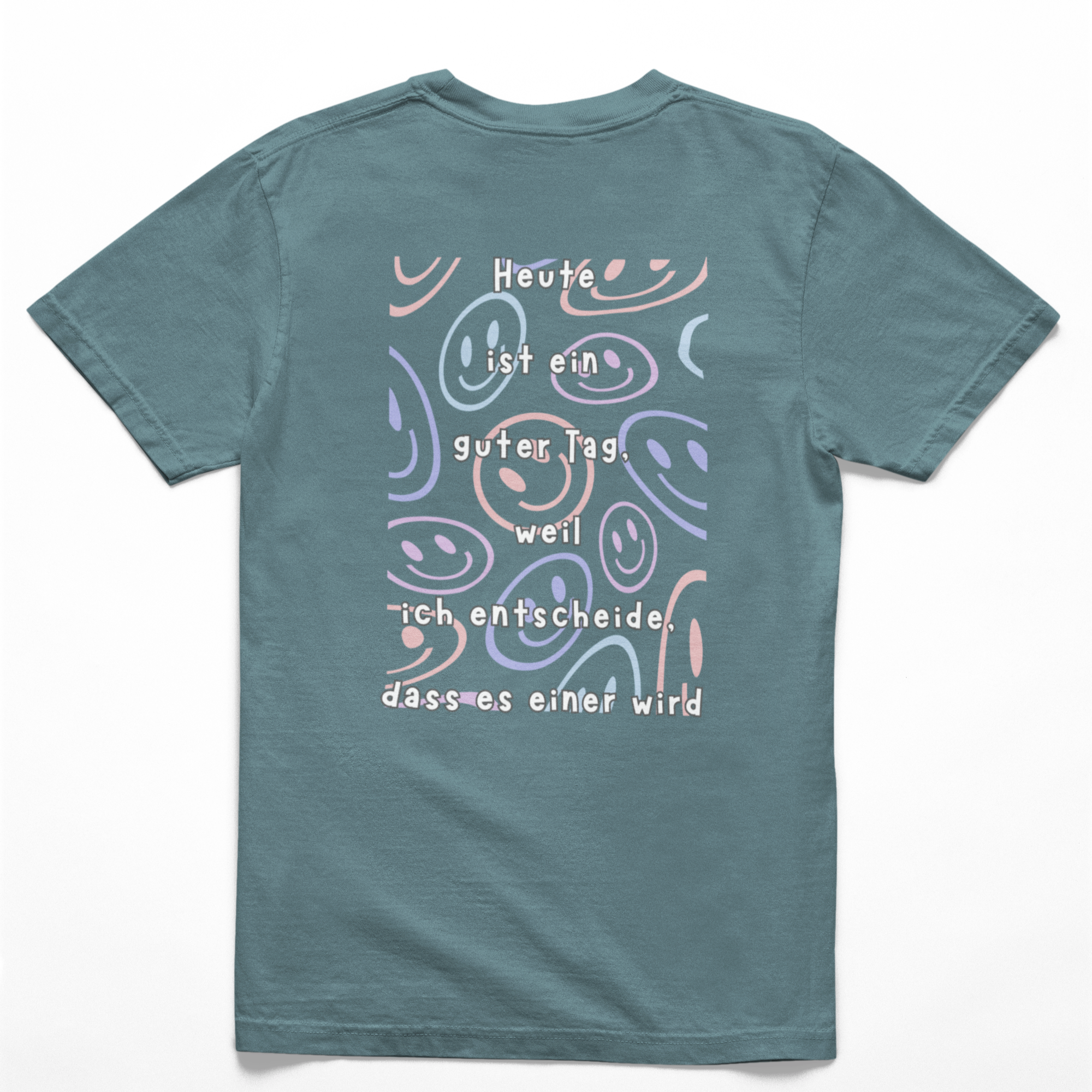 Rückseite eines tealfarbiges Kinder-T-Shirts mit farbenfrohem Smiley-Muster und dem Spruch: ‚Heute ist ein guter Tag, weil ich entscheide, dass es einer wird.‘