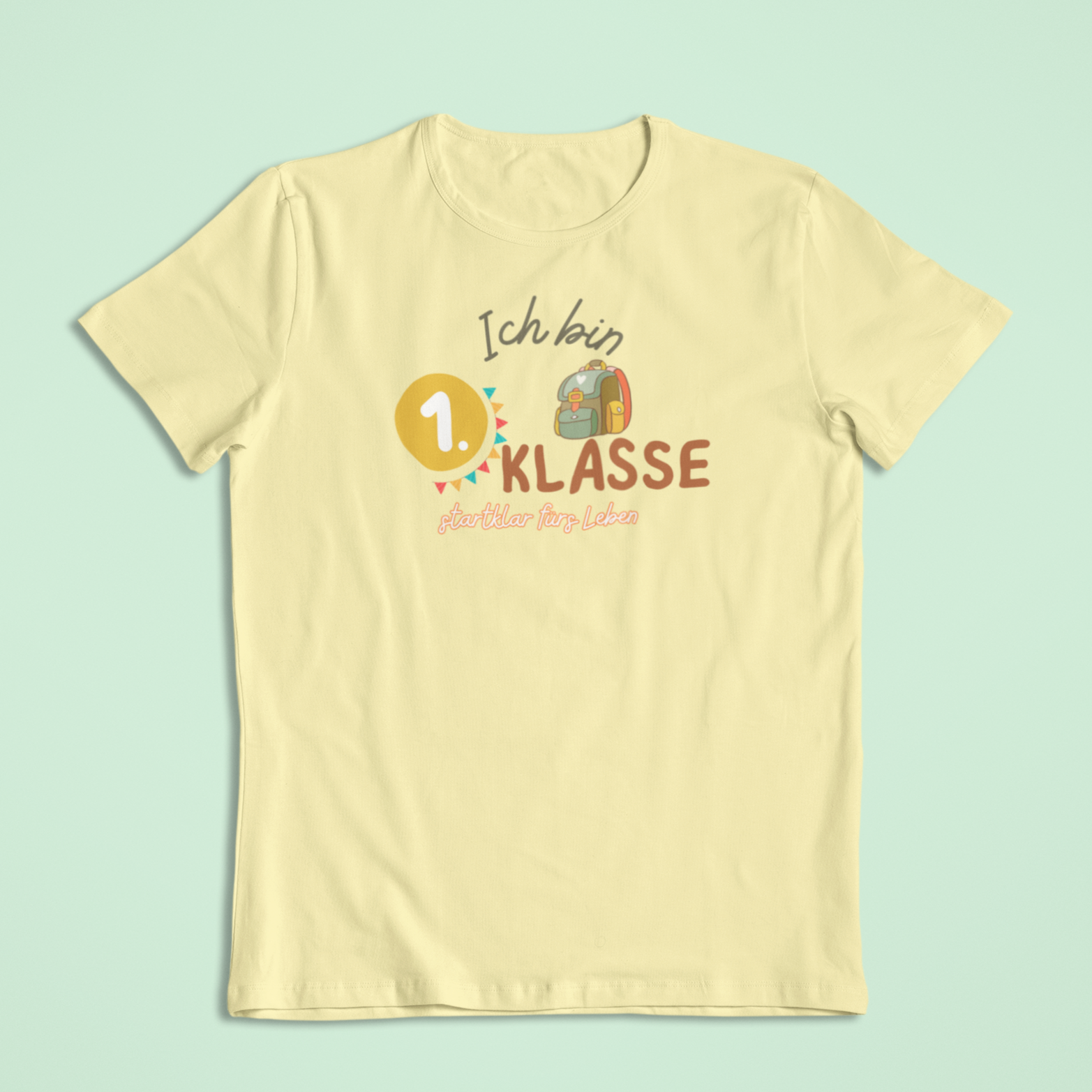 T-Shirt in Gelb mit dem Aufdruck: Ich bin 1. Klasse – startklar fürs Leben. Bio-Einschulungs-T-Shirt von Sinachtsam