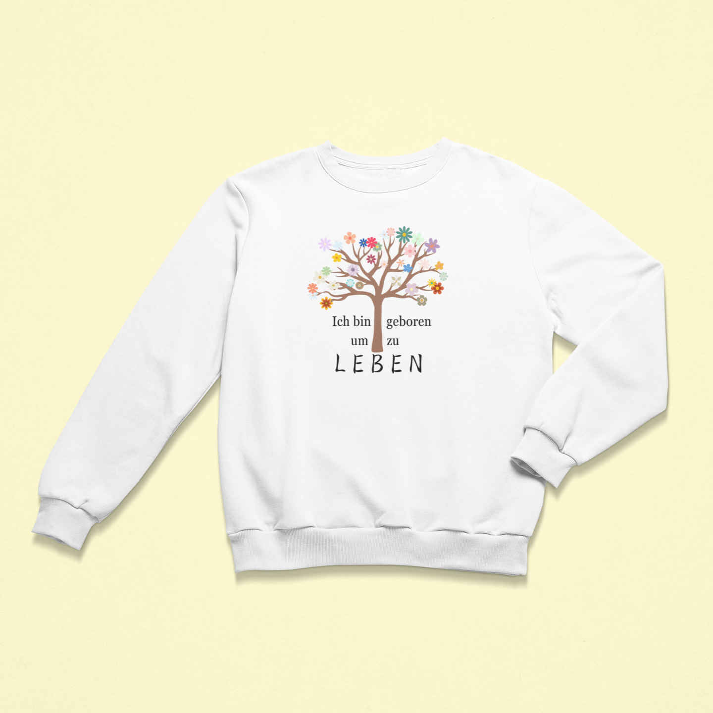 Weißes Kinder-Sweatshirt mit der Aufschrift „Ich bin geboren um zu leben“, begleitet von einem bunten Lebensbaum mit vielen farbigen Blüten. Das Design strahlt Lebensfreude, Selbstwert und Achtsamkeit aus.